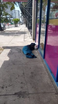 Homeless sleeping next to a 99 cent only store