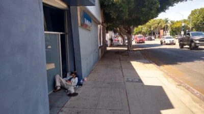 Homeless sleeping next to the street